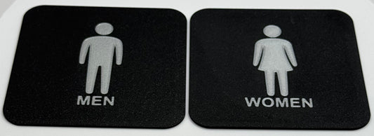 Toilet bordjes / WC bordjes met een man en een vrouw erop.Schuin aanzicht