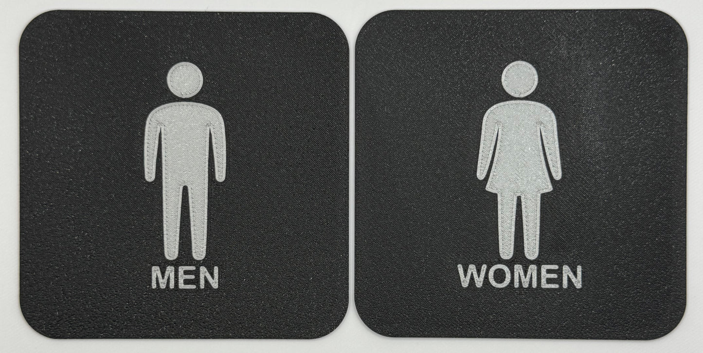 Toilet / WC bordjes met een man en een vrouw erop.