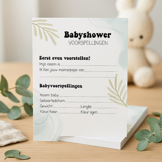 Babyshower invulkaart met eucalyptus-ontwerp op houten tafel met eucalyptustakjes en gebreid knuffelkonijn