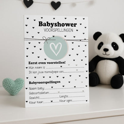 Zwart-wit babyshower invulkaart met hartjes op een witte dressoir met knuffelpanda en mint hartenkussen